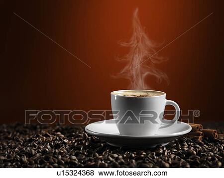 Download Christmas Tree Shaped Steam Rising Over A Cup Of Coffe Latte Standing On Coffee Beans Isolated On Dark Red Background Stock Photo U15324368 Fotosearch PSD Mockup Templates