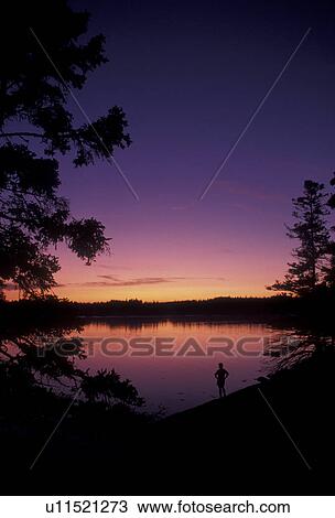 Acadia National Park, sunset, sunrise, Acadia, Maine, bay, Atlantic Ocean, Silhouette of person standing on Thompson Island looking out over the calm waters of the bay at sunset in Acadia Nat'l Park in the state of Maine. View Large Photo Image Stock Image - Acadia National Park, sunset, sunrise, Acadia, Maine, bay, Atlantic Ocean, Silhouette of person standing on Thompson Island looking out over the calm waters of the bay at sunset in Acadia Nat'l Park in the state of Maine.. Fotosearch
