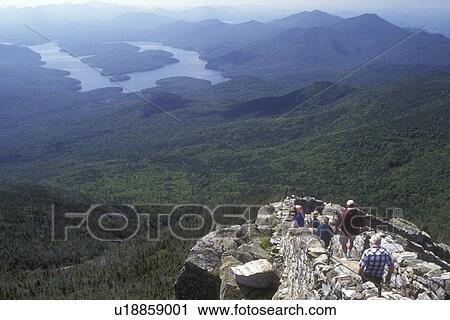 Stock Image -  Adirondack Park, Adirondacks, New York, Scenic overlook from Whiteface Mountain in Wilmington in the state of New York. People walking down trail from summit.. Fotosearch