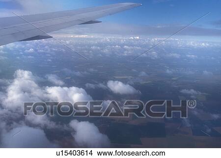airplane, France, Europe, The wing of a US Airways plane flying over clouds above the country of France. View Large Photo Image Picture - airplane, France, Europe, The wing of a US Airways plane flying over clouds above the country of France.. Fotosearch