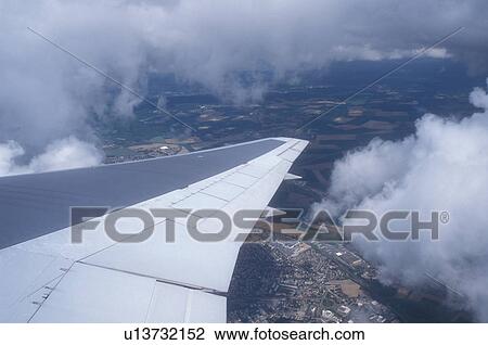 airplane, France, Europe, The wing of a US Airways plane flying through clouds above the country of France getting ready for landing. View Large Photo Image Stock Image - airplane, France, Europe, The wing of a US Airways plane flying through clouds above the country of France getting ready for landing.. Fotosearch