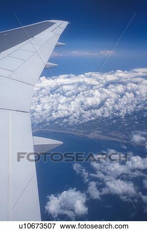 airplane, France, Europe, The wing of a US Airways plane flying over clouds above the country of France. View Large Photo Image Stock Photo - airplane, France, Europe, The wing of a US Airways plane flying over clouds above the country of France.. Fotosearch