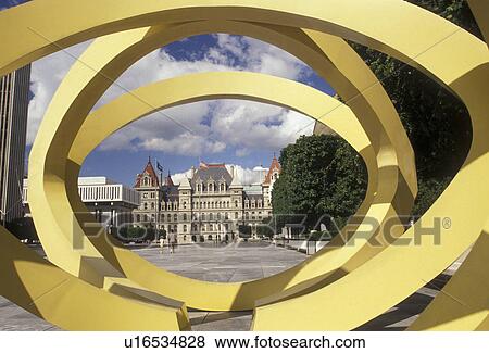 Stock Photo -  Albany, State Capitol, State House, New York, A view of The State Capitol Building from a yellow oval sculpture at the Governor Nelson A. Rockefeller Empire State Plaza in Albany the capital city in the state of New York. . Fotosearch