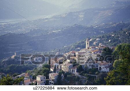Alps, France, Europe, A scenic view of the mountaintop village of Aspremont in the the French Alps in Alpes-Maritimes. Buildings made of stucco with red roofs. View Large Photo Image Picture - Alps, France, Europe, A scenic view of the mountaintop village of Aspremont in the the French Alps in Alpes-Maritimes. Buildings made of stucco with red roofs.. Fotosearch