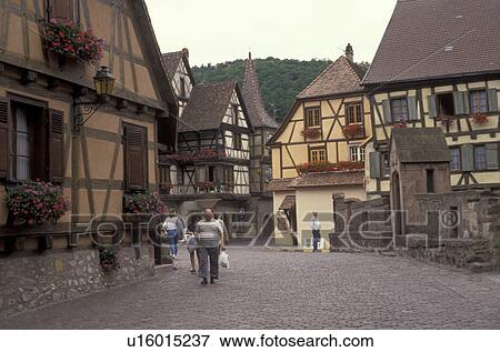 Alsace, France, Europe, Colmar, Haut Rhin, People walking on the cobbled streets in the city of Colmar, capital of Haut Rhin, with its half-timbered houses (Alsatian-style buildings) with flowers in window boxes. View Large Photo Image Stock Photo - Alsace, France, Europe, Colmar, Haut Rhin, People walking on the cobbled streets in the city of Colmar, capital of Haut Rhin, with its half-timbered houses (Alsatian-style buildings) with flowers in window boxes. . Fotosearch
