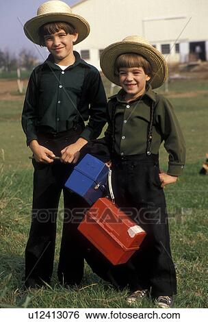 Amish, children, Pennsylvania, Lancaster County, White Horse, Two Amish boys in front a farm waiting for the Buggy Bus going to school in Lancaster County. The boys are wearing green shirts with black pants and traditional straw hats. They are carrying l View Large Photo Image Stock Photograph - Amish, children, Pennsylvania, Lancaster County, White Horse, Two Amish boys in front a farm waiting for the Buggy Bus going to school in Lancaster County. The boys are wearing green shirts with black pants and traditional straw hats. They are carrying l. Fotosearch