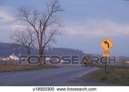 Amish, Pennsylvania, buggy, Lancaster County, Amish covered buggy traveling on a winding country road at dusk in Pennsylvania Dutch Country. View Large Photo Image Stock Image - Amish, Pennsylvania, buggy, Lancaster County, Amish covered buggy traveling on a winding country road at dusk in Pennsylvania Dutch Country.. Fotosearch