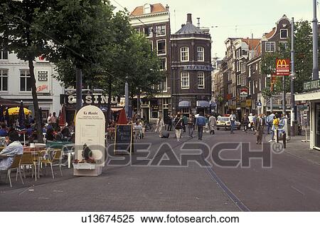 Amsterdam, Holland, Netherlands, Europe, Outdoor cafes and shops along the street in downtown Amsterdam. View Large Photo Image Stock Photography - Amsterdam, Holland, Netherlands, Europe, Outdoor cafes and shops along the street in downtown Amsterdam.. Fotosearch