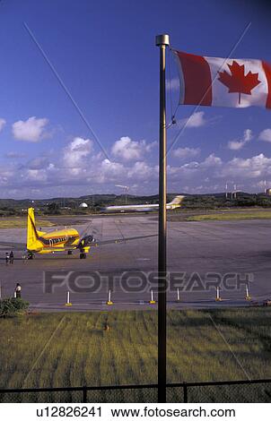 Antigua, airport, Caribbean, Caribbean Sea, Canadian flag flies at the V. C. Bird International Airport on the island of Antigua (a British Commonwealth member). View Large Photo Image Stock Image - Antigua, airport, Caribbean, Caribbean Sea, Canadian flag flies at the V. C. Bird International Airport on the island of Antigua (a British Commonwealth member). . Fotosearch