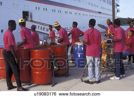 Stock Photograph -  Antigua, cruise, steel drum, Caribbean, St. John's, Caribbean Islands, Steel drum band playing traditional island music for the arrival of a cruise ship on St. John's Harbor in St. John's the capital of the island of Antigua (a British Commonwealth membe. Fotosearch