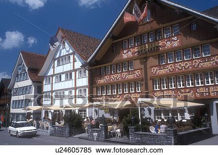 Appenzell, outdoor cafe, Switzerland, Europe, An outdoor cafe sits in front of a beautiful building constructed of wood and adorned with brightly painted designs in downtown Appenzell in the Canton of Appenzell. View Large Photo Image Stock Photography - Appenzell, outdoor cafe, Switzerland, Europe, An outdoor cafe sits in front of a beautiful building constructed of wood and adorned with brightly painted designs in downtown Appenzell in the Canton of Appenzell. . Fotosearch