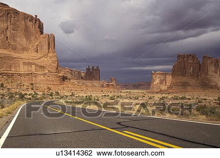 Arches, Arches National Park, Utah, The park road passes along Courthouse Towers a natural rock formation in Arches Nat'l Park in the state of Utah. Dark grey storm clouds in the distance. View Large Photo Image Stock Image - Arches, Arches National Park, Utah, The park road passes along Courthouse Towers a natural rock formation in Arches Nat'l Park in the state of Utah. Dark grey storm clouds in the distance.. Fotosearch