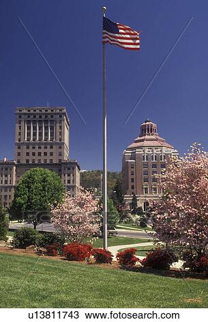 Asheville, North Carolina, The U. S. flag flies in a park in front of City Hall and the Courthouse in the springtime in Asheville in the state of North Carolina View Large Photo Image Stock Image - Asheville, North Carolina, The U. S. flag flies in a park in front of City Hall and the Courthouse in the springtime in Asheville in the state of North Carolina . Fotosearch