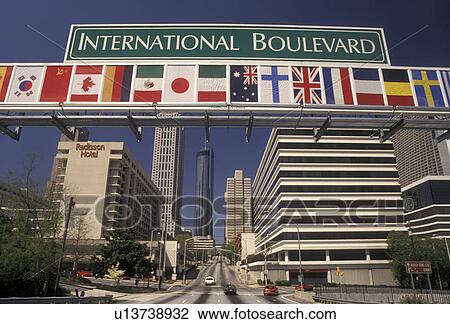 Stock Image -  Atlanta, downtown, Georgia, Street sign with flags of the countries of the world displayed above International Boulevard in downtown Atlanta in the state of Georgia.. Fotosearch