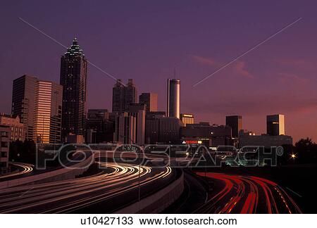 Atlanta, downtown skyline, Georgia, Skyline of downtown Atlanta and streaks of car lights on Downtown Connector Interstate I-85/I-75 from North Avenue at sunset in the state of Georgia. View Large Photo Image Stock Image - Atlanta, downtown skyline, Georgia, Skyline of downtown Atlanta and streaks of car lights on Downtown Connector Interstate I-85/I-75 from North Avenue at sunset in the state of Georgia. . Fotosearch