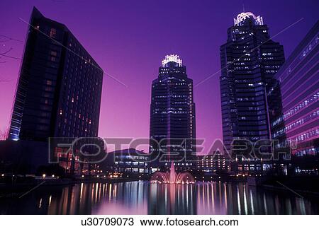 Stock Image -  Atlanta, Dunwoody, Georgia, Scenic view of the Concourse Buildings reflecting in a pond at sunset in Atlanta in the state of Georgia.. Fotosearch