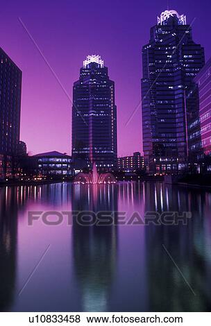 Stock Photo -  Atlanta, Georgia, Dunwoody, Scenic view of the Concourse Buildings reflecting in a pond at sunset in Atlanta in the state of Georgia.. Fotosearch