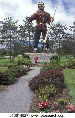 Bangor, Maine, Paul Bunyan, A woman stands below the giant statue of Paul Bunyan in a park in Bangor. View Large Photo Image Stock Photo - Bangor, Maine, Paul Bunyan, A woman stands below the giant statue of Paul Bunyan in a park in Bangor.. Fotosearch