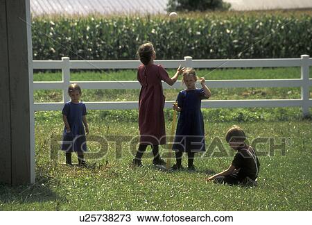 Stock Image -  baseball, softball, Lancaster County, Pennsylvania, Pennsylvania Dutch Country, Amish children/kids playing baseball/softball in Lancaster County in the state of Pennsylvania. . Fotosearch