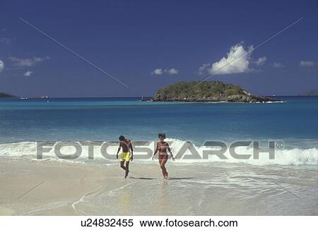 beach, U. S. Virgin Islands, St. John, Caribbean, Virgin Islands, USVI, U. S. V. I Couple walking up to the beach after swimming at Cinnamon Bay at Virgin Islands National Park on Saint John Island, US Virgin Islands. View Large Photo Image Stock Photography - beach, U. S. Virgin Islands, St. John, Caribbean, Virgin Islands, USVI, U. S. V. I Couple walking up to the beach after swimming at Cinnamon Bay at Virgin Islands National Park on Saint John Island, US Virgin Islands. . Fotosearch
