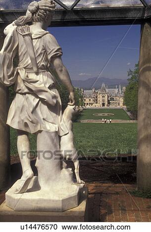 Stock Image -  Biltmore House, Asheville, Biltmore Estate, chateau, Biltmore, North Carolina, A statue on the Biltmore Estate's Vista with a view of The Biltmore House a French Renaissance-style chateau in Asheville in the state of North Carolina.. Fotosearch