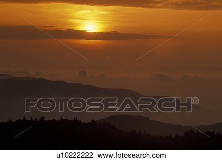 Stock Image -  Blue Ridge Parkway, Blue Ridge, sunrise, sunset, North Carolina, Appalachian Mountains, Scenic view of fog over the mountains at sunrise from the Blue Ridge Pkwy in the state of North Carolina.. Fotosearch