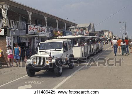 Stock Photography -  boardwalk, Ocean City, Maryland, Atlantic Ocean, Sightseeing caravan travels slowly along the boardwalk in Ocean City in the state of Maryland. . Fotosearch
