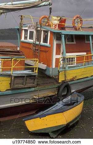 boats, Chile, Chiloe Island, Colorful fishing boats beached at low tide on the Pacific Ocean in Castro on Chiloe Island in Chile. View Large Photo Image Stock Image - boats, Chile, Chiloe Island, Colorful fishing boats beached at low tide on the Pacific Ocean in Castro on Chiloe Island in Chile.. Fotosearch