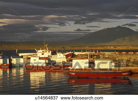 boats, Patagonia, Chile, Pacific Ocean, Andes, Sun shines on fishing boats in the harbor at sunrise in Puerto Natales in Chile. View Large Photo Image Stock Photo - boats, Patagonia, Chile, Pacific Ocean, Andes, Sun shines on fishing boats in the harbor at sunrise in Puerto Natales in Chile.. Fotosearch