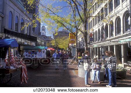 Boston, Massachusetts, People walking through Quincy Market in downtown Boston View Large Photo Image Stock Photo - Boston, Massachusetts, People walking through Quincy Market in downtown Boston . Fotosearch