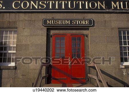 Stock Image -  Boston, U. S. S. Constitution, Massachusetts, Charlestown Navy Yard, Red door at the entrance to the USS Constitution Museum Store in Boston in the state of Massachusetts. . Fotosearch