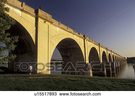 Stock Image -  bridge, Harrisburg, Pennsylvania, Susquehanna River, An arched stone bridge spans across the calm waters of the Susquehanna River in Harrisburg in the state of Pennsylvania.. Fotosearch