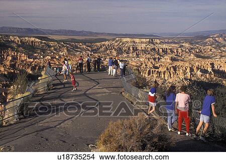 Picture -  Bryce Canyon, Bryce Canyon National Park, Paunsaugunt Plateau, Utah, People taking in the spectacular view at an overlook in Bryce Canyon Nat'l Park in the state of Utah.. Fotosearch