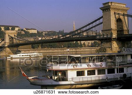 Budapest, Hungary, Europe, bridge, Scenic view of the Chain Bridge crossing the Danube (Donau) River and the capital city of Budapest at night. Tour boats take tourists on excursions on the Danube River. View Large Photo Image Stock Image - Budapest, Hungary, Europe, bridge, Scenic view of the Chain Bridge crossing the Danube (Donau) River and the capital city of Budapest at night. Tour boats take tourists on excursions on the Danube River.. Fotosearch