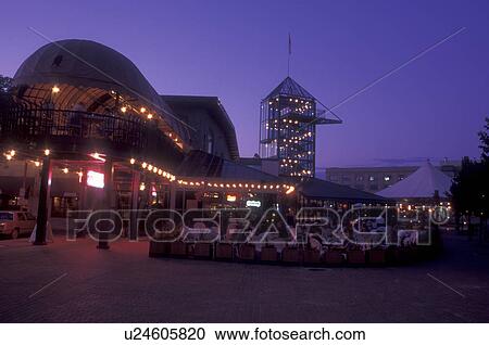Stock Image -  Canada, Manitoba, Winnipeg, Cafe outside The Johnston Terminal in the evening at the Forks in Winnipeg houses the Manitoba Sports Hall of Fame and Curling Hall of Fame.. Fotosearch