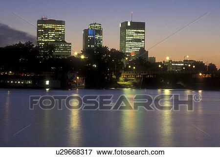 Canada, Manitoba, Winnipeg, The illuminated downtown skyline of Winnipeg reflects on the waters of the Red River in the evening. View Large Photo Image Stock Photo - Canada, Manitoba, Winnipeg, The illuminated downtown skyline of Winnipeg reflects on the waters of the Red River in the evening.. Fotosearch
