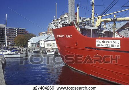 Stock Photo -  Canada, Ontario, Kingston, A red ship is displayed at the Marine Museum of the Great Lakes on the St. Lawrence River in Kingston.. Fotosearch