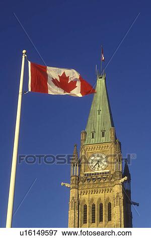 Canada, Ontario, Ottawa, A Canadian flag flies next to the Peace Tower of the Parliament Buildings on Parliament Hill in Ottawa. View Large Photo Image Stock Photo - Canada, Ontario, Ottawa, A Canadian flag flies next to the Peace Tower of the Parliament Buildings on Parliament Hill in Ottawa.. Fotosearch