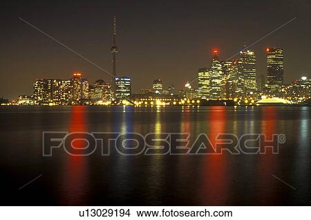 Canada, Ontario, Toronto, The illuminated downtown skyline of Toronto reflects in the waters of Lake Ontario at night (evening). View Large Photo Image Picture - Canada, Ontario, Toronto, The illuminated downtown skyline of Toronto reflects in the waters of Lake Ontario at night (evening).. Fotosearch