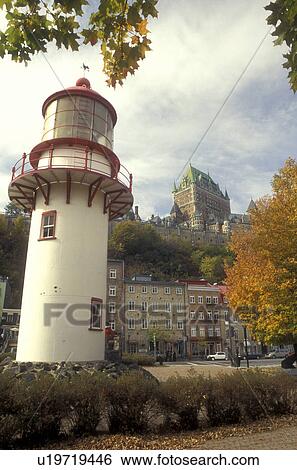 Stock Photograph -  Canada, Quebec, A red and white lighthouse is in the foreground of the Quartier Petit-Champlain and Chateau Frontenac of Quebec City in the fall., . Fotosearch