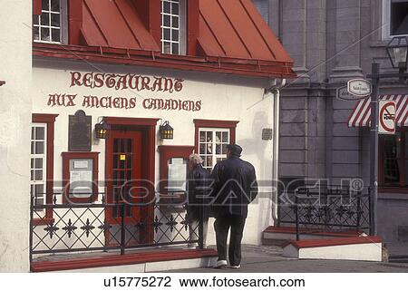 Canada, Quebec, Couple reading menu in front of restaurant with red roof along Rue St. Louis in Old Quebec City View Large Photo Image Stock Image - Canada, Quebec, Couple reading menu in front of restaurant with red roof along Rue St. Louis in Old Quebec City . Fotosearch