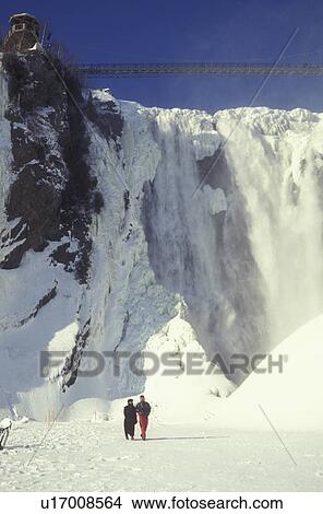 Canada, Quebec, Couple walking by the frozen waterfall at Parc de la Chute-Montmorency., View Large Photo Image Picture - Canada, Quebec, Couple walking by the frozen waterfall at Parc de la Chute-Montmorency., . Fotosearch