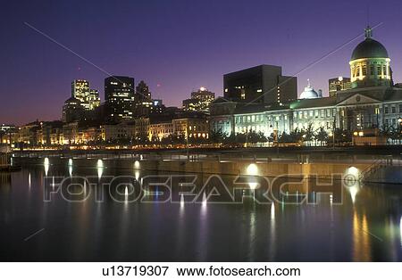 Stock Photo -  Canada, Quebec, Montreal, Skyline of downtown Montreal reflects in the calm waters of the St. Lawrence River (Fleuve Saint-Laurent) at Vieux Port in the evening. Fotosearch