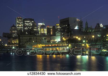 Canada, Quebec, Montreal, The illuminated skyline of downtown Montreal reflects in the waters of the St. Lawrence River (Fleuve Saint-Laurent) at Vieux Port in the evening. View Large Photo Image Stock Image - Canada, Quebec, Montreal, The illuminated skyline of downtown Montreal reflects in the waters of the St. Lawrence River (Fleuve Saint-Laurent) at Vieux Port in the evening. . Fotosearch