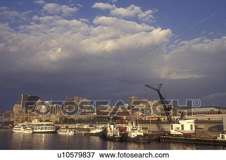 Stock Photo -  Canada, Quebec, Montreal, Vieux Port and skyline of downtown Montreal on the waters of St. Lawrence River (Fleuve Saint-Laurent).. Fotosearch