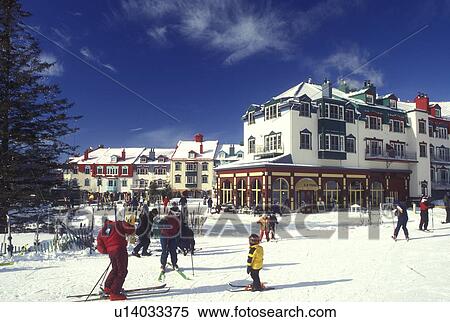 Stock Photography -  Canada, Quebec, People skiing at Tremblant Ski Resort at Mont Tremblant. The village has an Old Quebec City atmosphere . Fotosearch