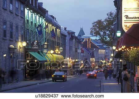 Canada, Quebec, People walking along Rue St. Louis past hotels, cafes, and shops in Old Quebec City at night (evening). View Large Photo Image Stock Photo - Canada, Quebec, People walking along Rue St. Louis past hotels, cafes, and shops in Old Quebec City at night (evening).. Fotosearch