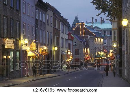 Stock Photography -  Canada, Quebec, People walking along Rue St. Louis past hotels, cafes, and shops in Old Quebec City at night.. Fotosearch
