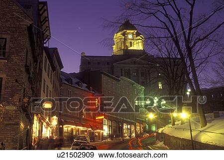 Stock Photo -  Canada, Quebec, Quartier Petit Champlain in Old Quebec City is illuminated at night (evening) in winter., . Fotosearch