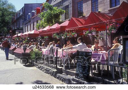 Stock Photo -  Canada, Quebec, Quebec City, People sitting at outdoor [cafe, restaurant] along Grande-Allee in Quebec City.. Fotosearch